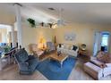 Cozy living room with vaulted ceilings, ceiling fan, comfortable seating, and lots of natural light at 5906 Garden Lakes Majestic, Bradenton, FL 34203