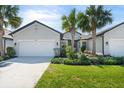 Inviting home with a lush green lawn, tasteful landscaping, and a clean, well-maintained exterior facade at 5998 Amberly Dr, Bradenton, FL 34208