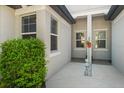 Inviting front porch featuring neutral colors, clean lines, and lush greenery, creating a welcoming entrance at 5998 Amberly Dr, Bradenton, FL 34208