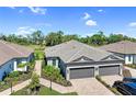 A bird's-eye view showcases the home's roof, landscaping, driveway, and proximity to green spaces at 6179 Mesa Gln, Bradenton, FL 34203