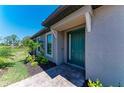 Stylish front door with decorative trim and a well-kept garden at 6179 Mesa Gln, Bradenton, FL 34203