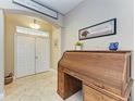 Inviting home foyer with tile flooring, a vintage desk, and an open archway at 6415 Fetterbush Ln, Lakewood Ranch, FL 34202