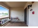 Cozy outdoor seating on the balcony offers a relaxing space with a small table and chairs at 7151 Wood Creek Dr # 205, Sarasota, FL 34231