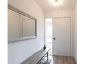 Bright entryway features neutral walls, a bench with a mirror, and a view of the front door at 7151 Wood Creek Dr # 205, Sarasota, FL 34231