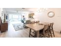 Open-concept living and dining area featuring neutral decor, tile floors, and lots of natural light at 7151 Wood Creek Dr # 205, Sarasota, FL 34231