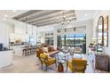 Open-concept living room with modern furniture, high ceilings, and a view of the backyard at 7211 Prestbury Cir, Lakewood Ranch, FL 34202