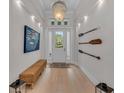 Bright entryway with white walls, hardwood floors, and stylish decor at 8847 Colonels Ct, Sarasota, FL 34240