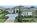 Elegant home with paved driveway and lush landscaping at 8847 Colonels Ct, Sarasota, FL 34240
