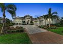 Beautiful home with manicured landscaping, brick-lined driveway and three-car garage at 8847 Colonels Ct, Sarasota, FL 34240