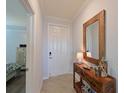 Inviting foyer with a decorative table and beach-themed decor, adjacent to the main bedroom at 1020 Tidewater Shores Loop # 107, Bradenton, FL 34208