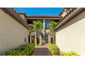 Beautiful entrance to the condominium with manicured landscaping and a lovely path at 13719 Messina Loop # 101, Lakewood Ranch, FL 34211
