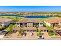 Beautiful condominium building with attached garages, lush landscaping and a gorgeous lake view at 13719 Messina Loop # 101, Lakewood Ranch, FL 34211