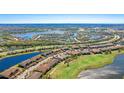 Beautiful aerial view showcases the community, golf course, and multiple lakes surrounding the property at 13719 Messina Loop # 101, Lakewood Ranch, FL 34211