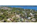 Aerial view showcasing this home's location among a mature treed neighborhood near the bay at 1406 5Th W St, Palmetto, FL 34221