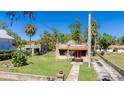 Charming stone home with a well-manicured lawn, unique architectural details, and a quaint walkway at 1406 5Th W St, Palmetto, FL 34221