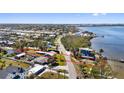 A bayfront home with dock outlined showing neighborhood and mature landscaping at 1815 Palma Sola Blvd, Bradenton, FL 34209