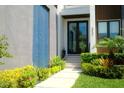 A welcoming entrance with tiled entryway, stone steps and garden area at 212 S Renellie Dr, Tampa, FL 33609