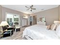 Spacious main bedroom featuring ample natural light, slider to lanai, and neutral tones at 22209 Deer Pointe Xing, Bradenton, FL 34202
