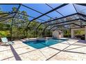 Relaxing screened-in pool and spa with lush landscaping, and cabana at 22209 Deer Pointe Xing, Bradenton, FL 34202
