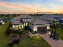 Stunning single-Gathering home boasts mature landscaping, brick paved driveway, and three-car garage at 3564 Santa Caterina Blvd, Lakewood Ranch, FL 34211