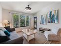 Bright living room with large window, neutral walls, and contemporary furnishings, filled with natural light at 4009 Crockers Lake Blvd # 25, Sarasota, FL 34238