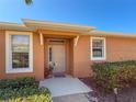 Inviting front entrance with a freshly painted door, well-lit walkway, and lush shrubbery at 4015 Bridlecrest Ln, Bradenton, FL 34209