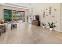 Spacious living room featuring sliding glass doors out to the lanai with outside seating area at 4015 Bridlecrest Ln, Bradenton, FL 34209