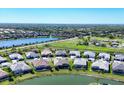 An aerial view capturing a neighborhood with lakeside homes, some featuring pools, in a lush, green environment at 4629 Antrim Dr, Sarasota, FL 34240