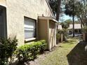 Exterior view of home, showing side yard with storage shed and lush landscaping at 4933 Village Gardens Dr # 211, Sarasota, FL 34234