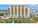 Beautiful multi-story condo building with balconies, manicured landscaping, water feature, and community pool at 501 Haben Blvd # 202, Palmetto, FL 34221