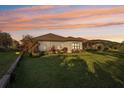 Expansive backyard with lush green lawn, decorative shrubs, and outdoor lighting, perfect for entertaining at 5203 Rushmere Ct, Palmetto, FL 34221