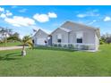 Single Gathering home with a well-manicured lawn and two-car garage at 566 Corrientes Cir, Punta Gorda, FL 33983