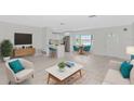 Bright living room with a modern kitchen, stylish furnishings, and ample natural light at 610 Cumberland Rd, Venice, FL 34293