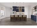 Stunning kitchen features a large island with bar seating, sleek stainless steel appliances, and modern pendant lighting at 6137 Grove Blvd, Punta Gorda, FL 33982