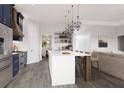 Bright kitchen features a large center island, stainless appliances, and open access to the living and dining areas at 6137 Grove Blvd, Punta Gorda, FL 33982