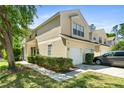 Well-maintained condo featuring attached garages, neat landscaping, and a bright exterior at 6320 Rosefinch Ct # 101, Lakewood Ranch, FL 34202