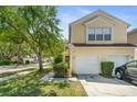 Attractive condo featuring an attached two-car garage and well-kept landscaping at 6320 Rosefinch Ct # 101, Lakewood Ranch, FL 34202