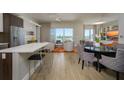 Open-concept layout with living area, dining space, and kitchen bar, with outdoor views at 635 S Orange Ave # 404, Sarasota, FL 34236