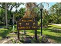 Welcome to Terraces Two sign surrounded by flowers and lush greenery at 6450 Wild Oak Bay Blvd # 240, Bradenton, FL 34210