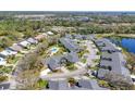 Scenic aerial of single-story homes with manicured lawns and mature landscaping, pool, shrubs, and garages at 6907 Stoneywalk Ct, Bradenton, FL 34203