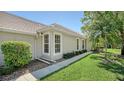 A well-manicured lawn and landscaping accentuate the home's exterior, highlighting its clean lines and design at 7004 Old Tabby Cir, Lakewood Ranch, FL 34202