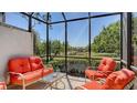 Relaxing screened patio with comfortable seating area and scenic views of lush greenery and tranquil lake at 7004 Old Tabby Cir, Lakewood Ranch, FL 34202
