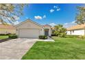 Charming single-story home featuring a well-manicured lawn and inviting curb appeal at 730 Foggy Morn Ln, Bradenton, FL 34212