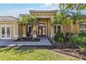 Inviting entryway with double doors and manicured landscaping, offering a glimpse of the well-maintained property at 742 Shadow Bay Way, Osprey, FL 34229