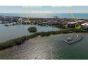 An aerial view featuring a marina, and waterfront restaurants near the Island Reef Condos at 8767 Midnight Pass Rd # 403F, Sarasota, FL 34242