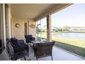 Relaxing screened-in lanai with comfortable seating and a serene view of the water at 8859 Founders Cir, Palmetto, FL 34221