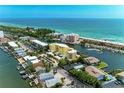 Stunning aerial view of the condo building nestled along the waterfront, offering serene coastal living at 9122 Midnight Pass Rd # 24, Sarasota, FL 34242