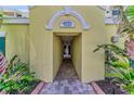 Inviting entrance to the condo building, featuring brick pavers and elegant architectural details at 9122 Midnight Pass Rd # 24, Sarasota, FL 34242