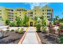 Lush landscaping adorns the front of the condo building with well-maintained grounds and a welcoming entrance at 9122 Midnight Pass Rd # 24, Sarasota, FL 34242