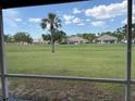 Screened lanai view showcasing serene golf course and neighborhood at 4906 Peridia E Blvd, Bradenton, FL 34203